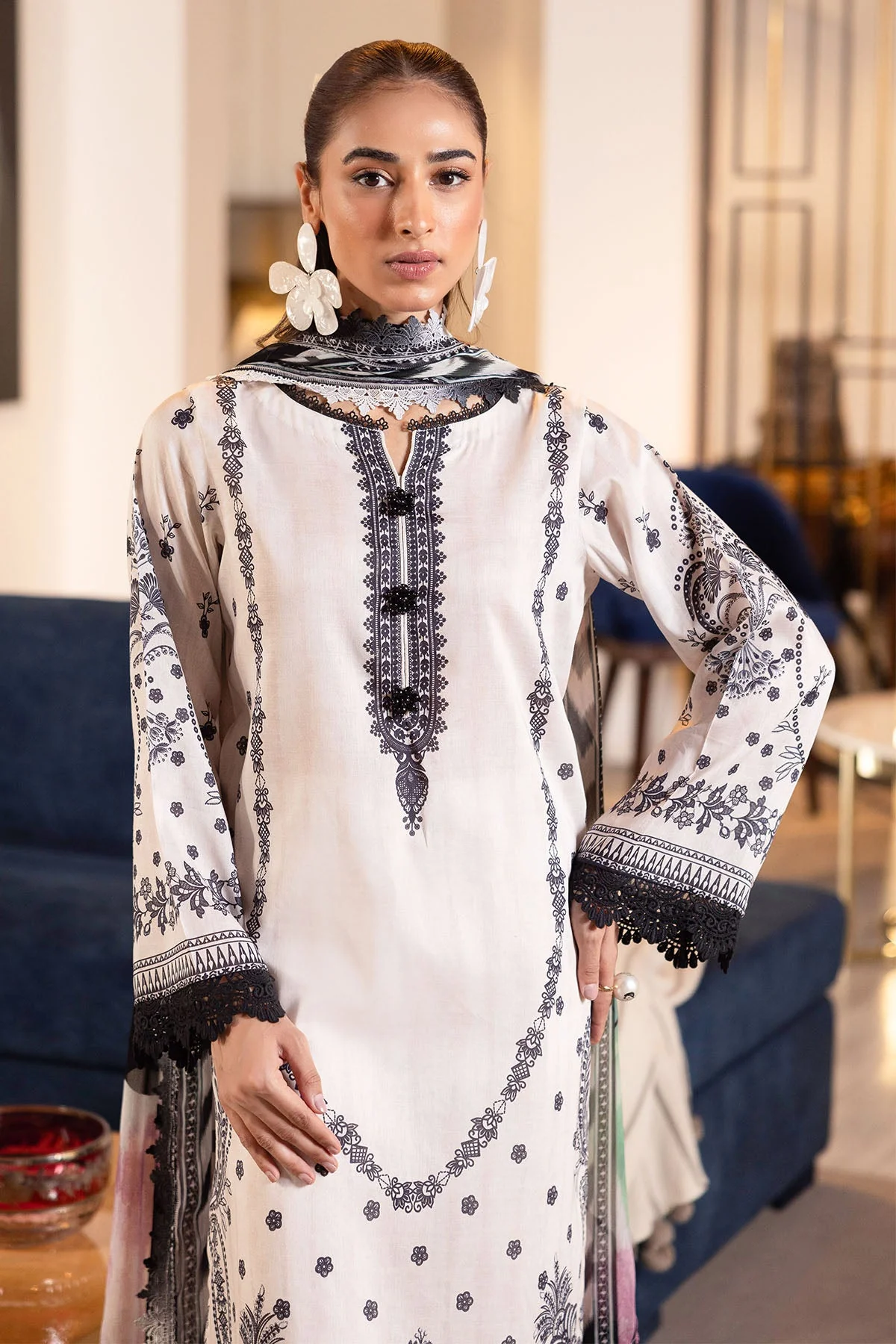 Model wearing Nureh Signature Lawn 3-Piece Stitched Suit in ivory and black embroidery with colorful abstract chiffon dupatta β Marina Mystique summer collection.