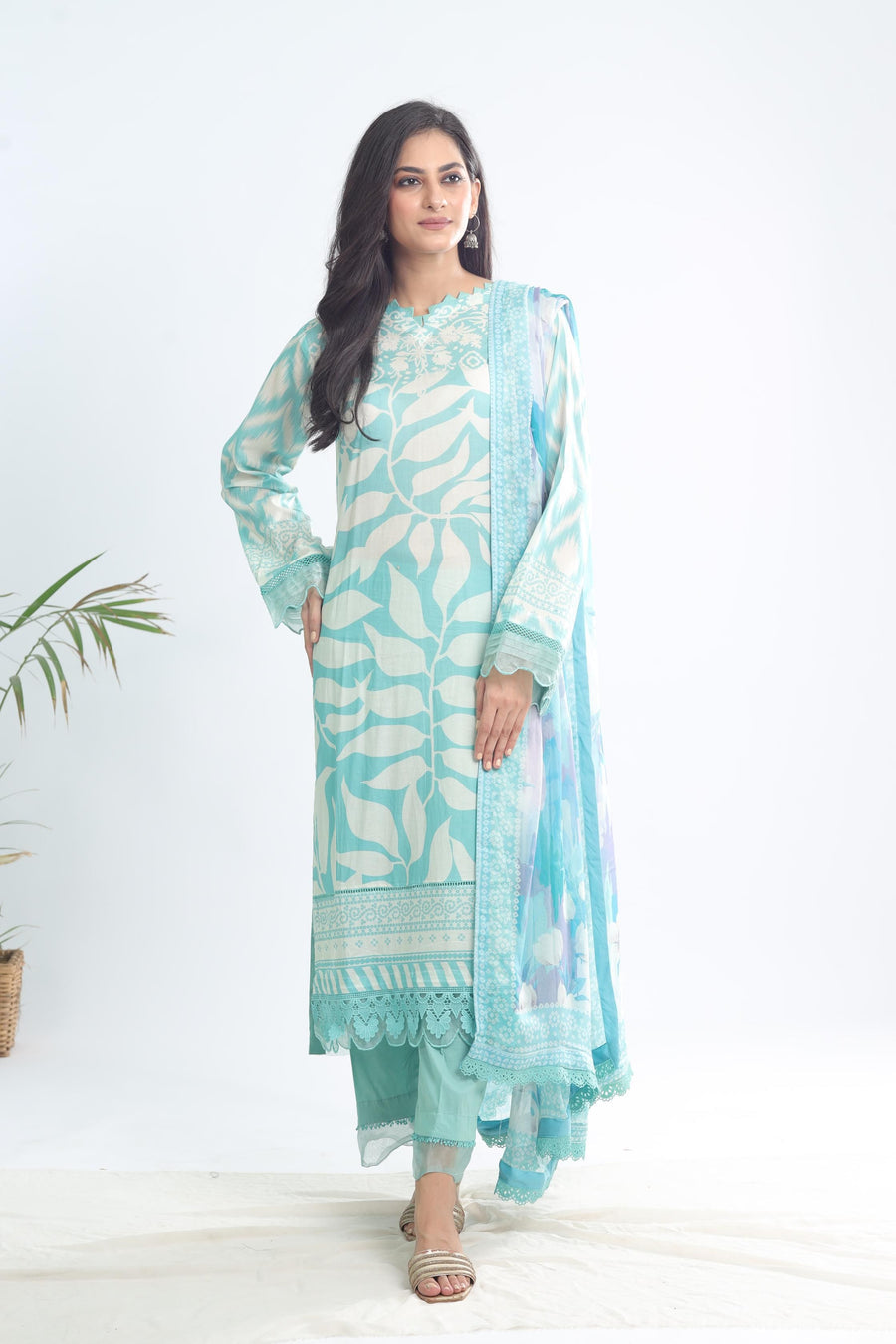 Model wearing Nureh SP-115 Signature Printed Lawn 3-Piece Stitched Suit in pastel sea-green with signature Nureh prints – Marina Mystique summer collection.