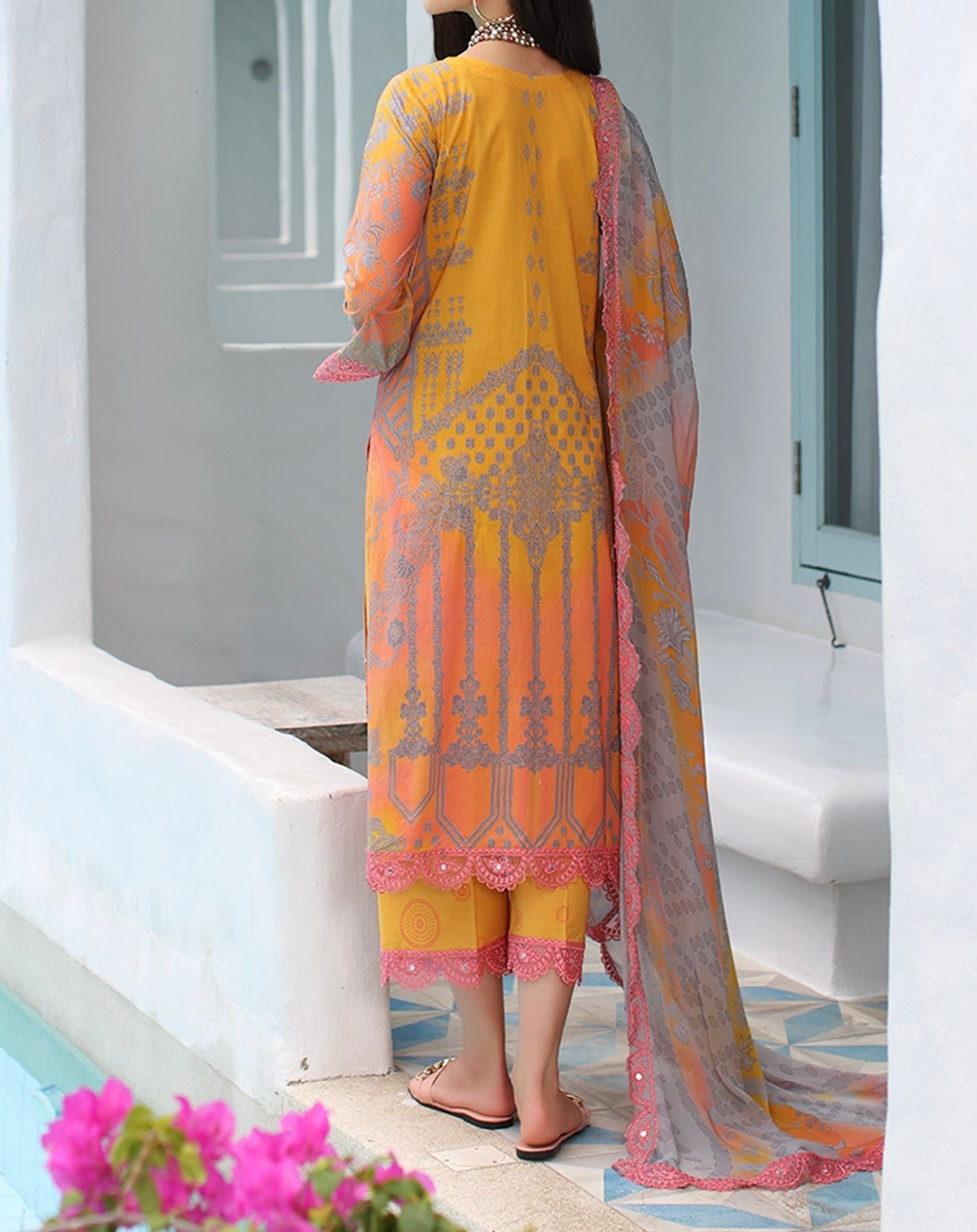 Back view of the printed orange pink lawn shirt paired with matching trousers.