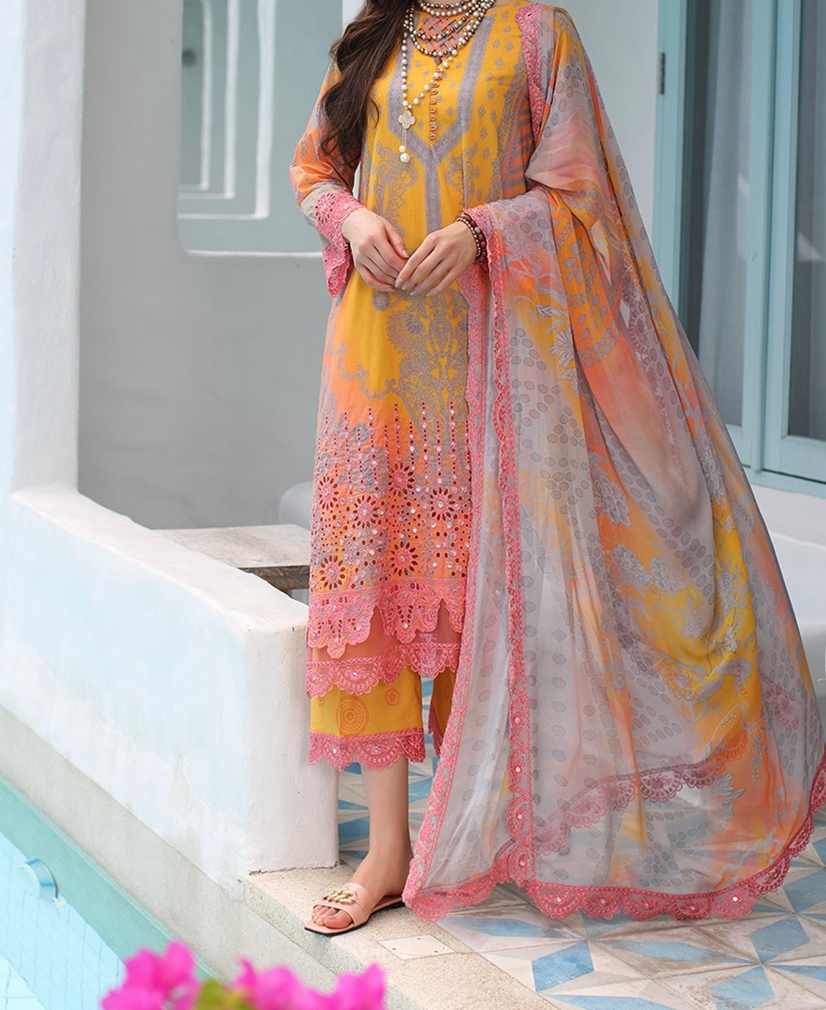 Front full-length view of the light orange pink embroidered lawn suit with flowing dupatta.